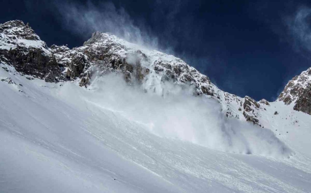 Avalanche cascading down snowy slope